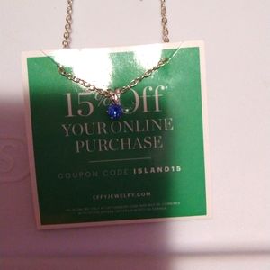 16 inch silver tone necklace with blue diamond cut stone pendant